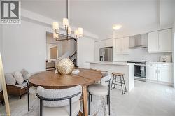 Dining space with a chandelier and stairway - 