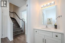 Bathroom featuring vanity and dark wood finished floors - 