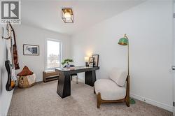 Office featuring light colored carpet and baseboards - 