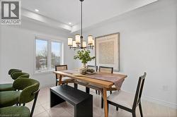 Dining space with a chandelier, light tile patterned flooring, and recessed lighting - 