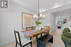 Dining room with a chandelier, light tile patterned floors, and recessed lighting - 