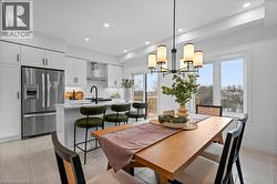 Dining area featuring recessed lighting and a chandelier - 