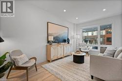 Living room featuring wood finished floors and recessed lighting - 