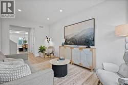 Living area with wood finished floors and recessed lighting - 