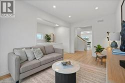 Living room with light wood-style floors and recessed lighting - 