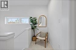 Living area with tile patterned floors and an upstairs landing - 