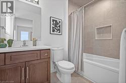 Full bathroom featuring vanity and shower / bath combo - 