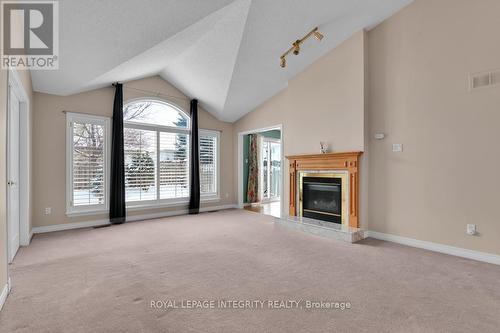 Living room with cathedral ceiling, gas fireplace - 49 Sai Crescent, Ottawa, ON - Indoor With Fireplace