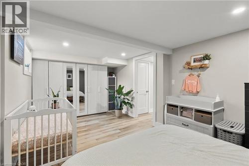 Bedroom featuring a crib, light wood finished floors, and recessed lighting - 40 Bula Drive, St. Catharines, ON - Indoor