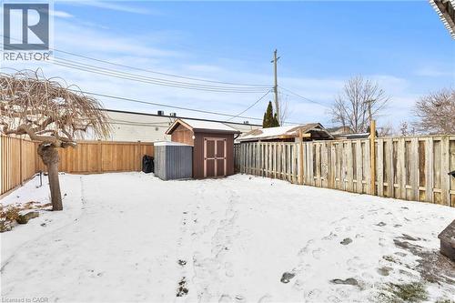 Snowy yard featuring a fenced backyard and a storage unit - 40 Bula Drive, St. Catharines, ON - Outdoor