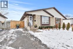 View of front of property with brick siding and a gate - 