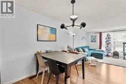 Dining space featuring a textured ceiling and light wood-style flooring - 