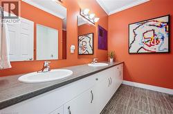 Full bath featuring double vanity and crown molding - 