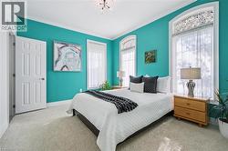 Bedroom featuring carpet, crown molding, and a chandelier - 