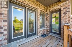 Doorway to property featuring brick siding - 