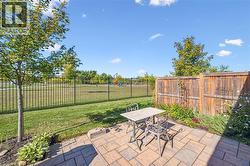Fenced backyard featuring outdoor dining space and a patio area - 