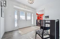 Foyer featuring a chandelier and ornamental molding - 