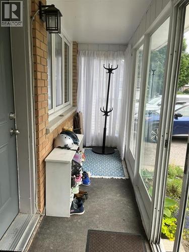 Sunroom / solarium featuring healthy amount of natural light, carpet flooring, and brick wall - 235 Fearnwood Street, Cambridge, ON -  With Exterior