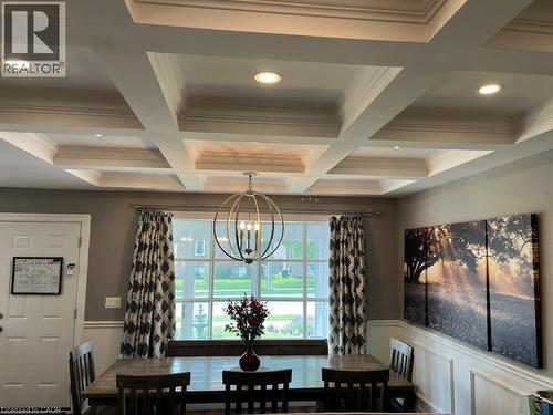 Dining room with beam ceiling, a chandelier, coffered ceiling, and a decorative wall - 235 Fearnwood Street, Cambridge, ON - Indoor Photo Showing Other Room
