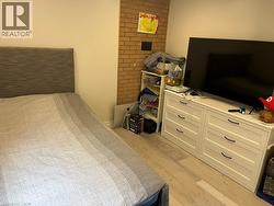 Bedroom with light wood finished floors - 