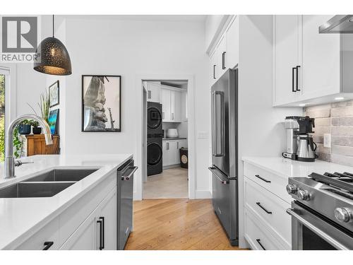 Kitchen with view into mud/laundry and 2 piece bathroom - 830 Westview Way Unit# 22, West Kelowna, BC - Indoor Photo Showing Kitchen With Double Sink With Upgraded Kitchen