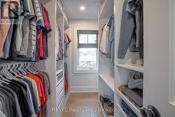 large walk in closet in primary suite w built ins - 