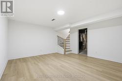 Family rm with laminate flrg, modern iron spindles - 