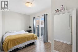 Bedroom featuring light wood finished floors and baseboards - 