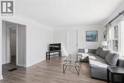 Living room featuring wood finished floors and baseboards - 