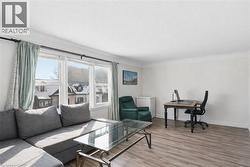 Living room featuring light wood-type flooring and an office area - 