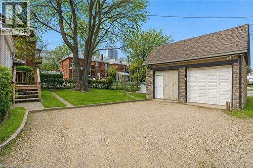 Detached two-car garage with stone-effect siding and shingle roof - 260 Prospect Street S, Hamilton, ON - Outdoor