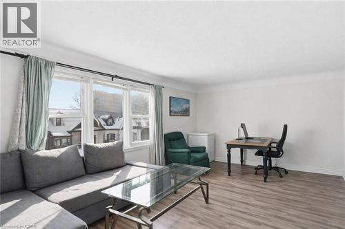 Living room featuring light wood-type flooring and an office area - 260 Prospect Street S, Hamilton, ON - Indoor Photo Showing Living Room