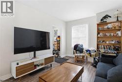 Living area featuring wood finished floors and baseboards - 