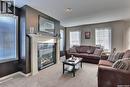 15 3101 Tregarva Drive E, Regina, SK  - Indoor Photo Showing Living Room With Fireplace 