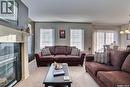 15 3101 Tregarva Drive E, Regina, SK  - Indoor Photo Showing Living Room With Fireplace 