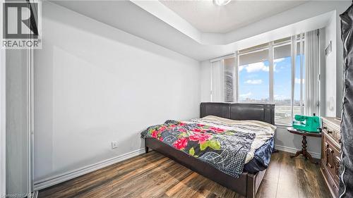 Bedroom featuring dark wood finished floors - 388 Prince Of Wales Drive Unit# 1609, Mississauga, ON - Indoor Photo Showing Bedroom