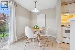 Dining space with healthy amount of natural light and light tile patterned floors - 
