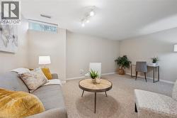 Living room featuring carpet floors and baseboards - 