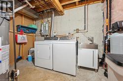 Laundry room with washing machine and clothes dryer, water heater, and electric panel - 