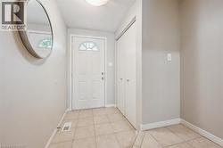 Entryway featuring a textured ceiling and light tile patterned flooring - 