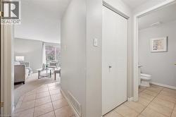 Hallway with light tile patterned floors and baseboards - 