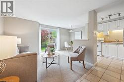 Living area featuring light tile patterned floors and baseboards - 