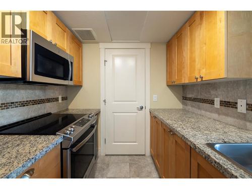 In suite laundry just off the kitchen. - 4205 Gellatly Road Unit# 416, West Kelowna, BC - Indoor Photo Showing Kitchen