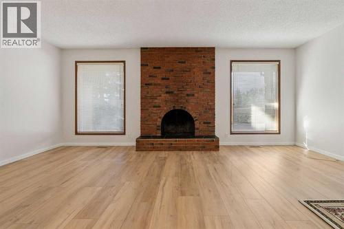 91 Edgehill Drive Nw, Calgary, AB - Indoor Photo Showing Living Room With Fireplace