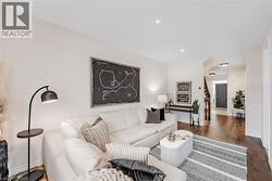 Living area featuring light wood finished floors and recessed lighting - 