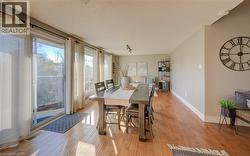 Dining space with a textured ceiling and light hardwood / wood-style flooring - 