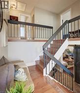 Staircase with a barn door and hardwood / wood-style flooring - 