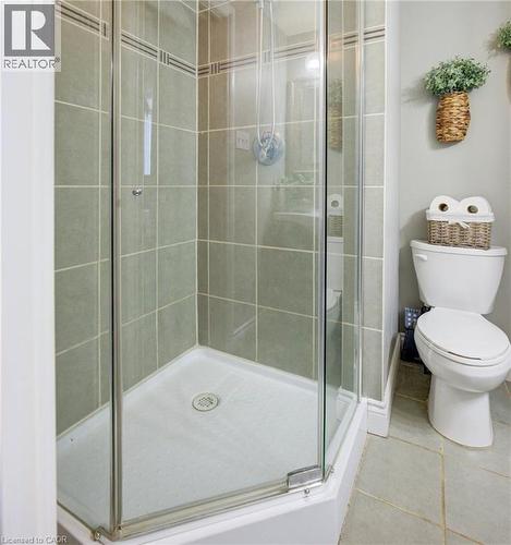 ensuite Bathroom with walk in shower, toilet, and tile patterned floors - 47 Manor Drive, Kitchener, ON - Indoor Photo Showing Bathroom