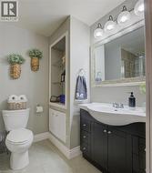 ensuite Bathroom with walk in shower, toilet, and tile patterned floors - 