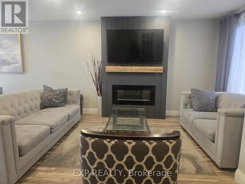 44 - 700 Harmony Road N, Oshawa, ON - Indoor Photo Showing Living Room With Fireplace